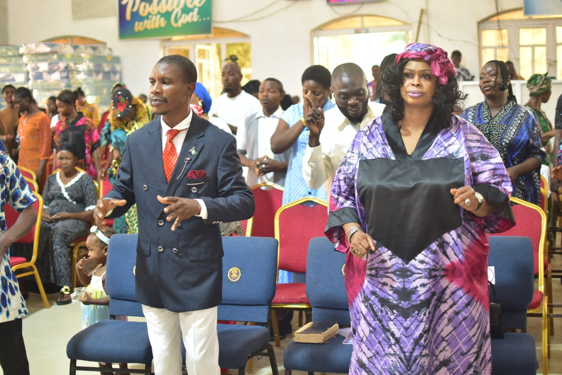 A man and a woman worshipping with expressive praise