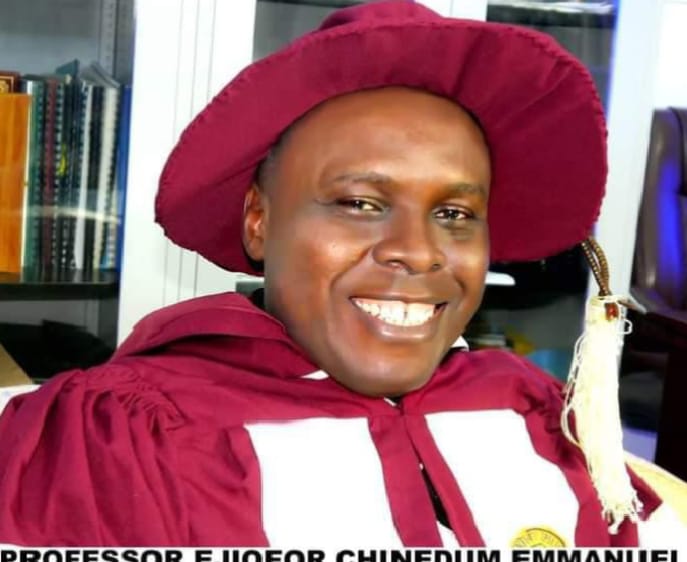 Apostle Prof. E. C. Ejiofor in maroon academic regalia with a tam and tassel, smiling โ a portrait of the General Overseer of Praiseland Royal Springs Int'l Church